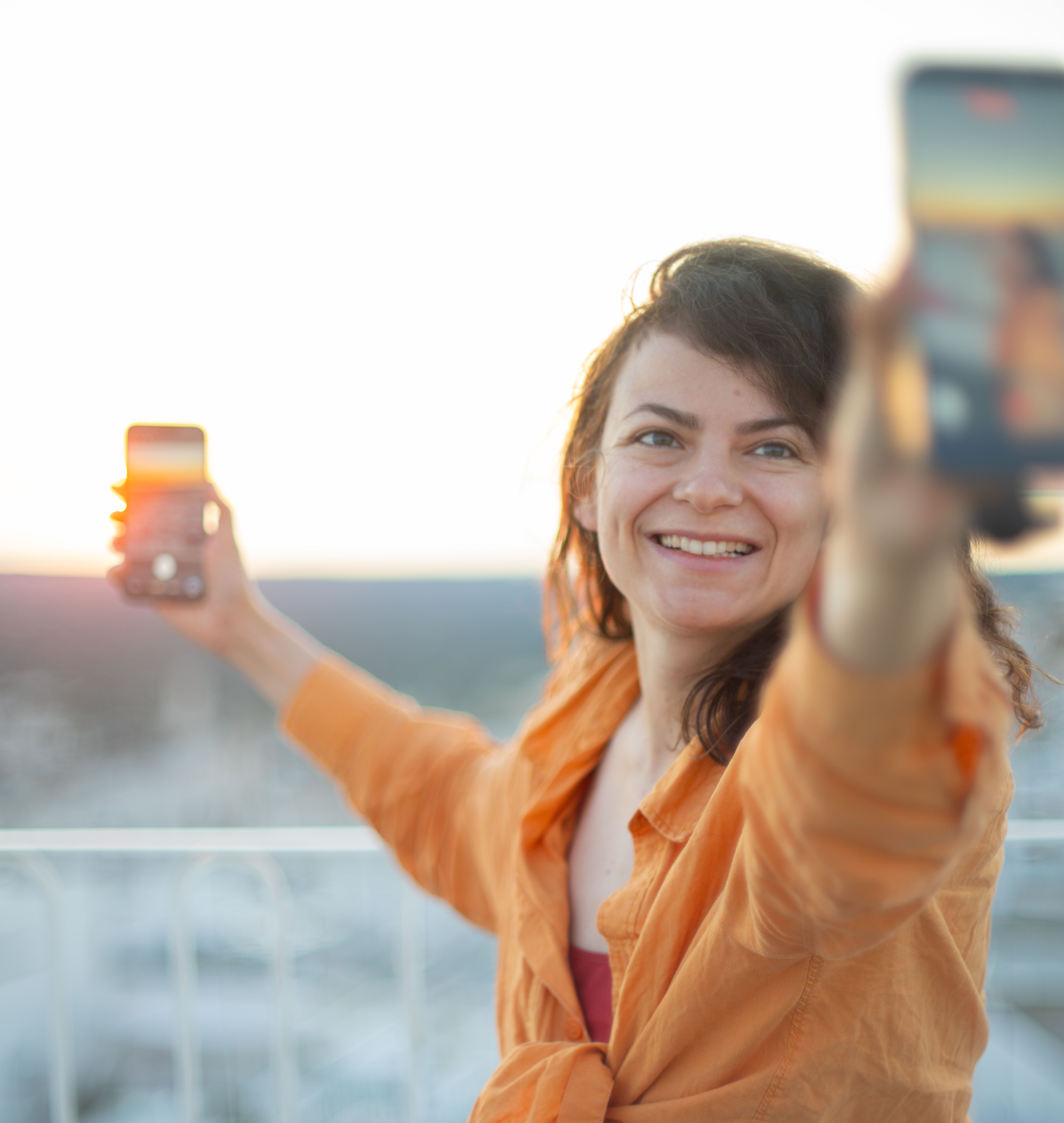 Travel creator in a red dress overlooking a Puglian coastal town